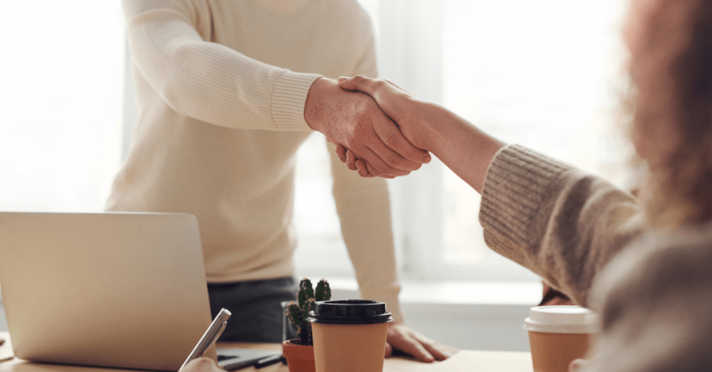 Online Business Coach Shaking Hands With Client