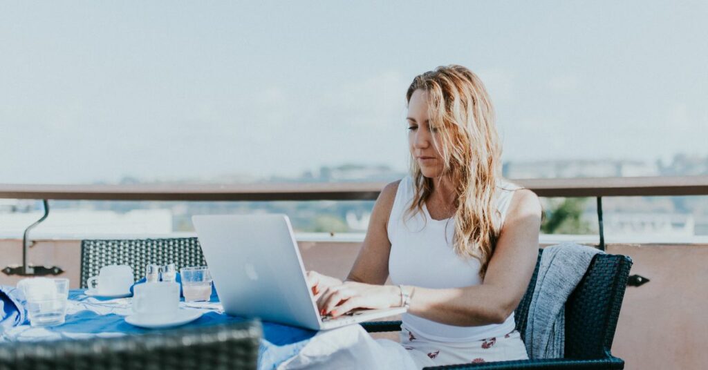 Woman works her digital nomad jobs with a view.
